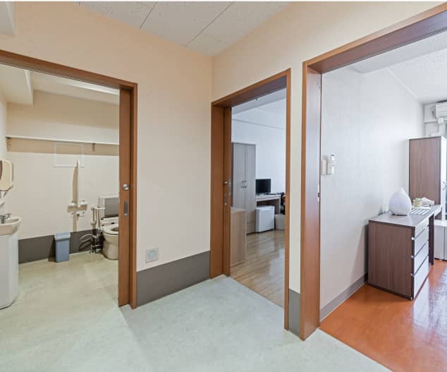 住宅の廊下から3つの部屋が見える間取り。トイレ、リビング、寝室が配置されている